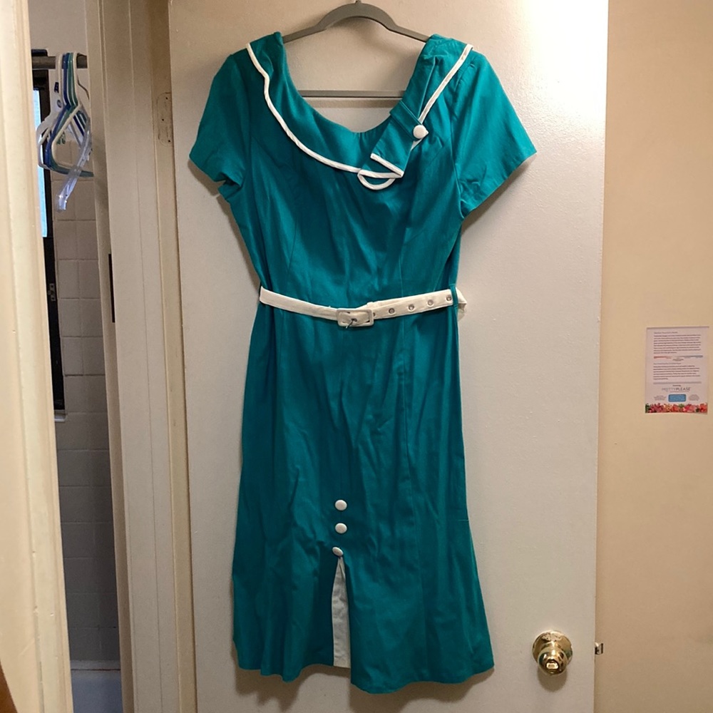 Voodoo Vixen retro-inspired dress in aquamarine with white accents and belt.